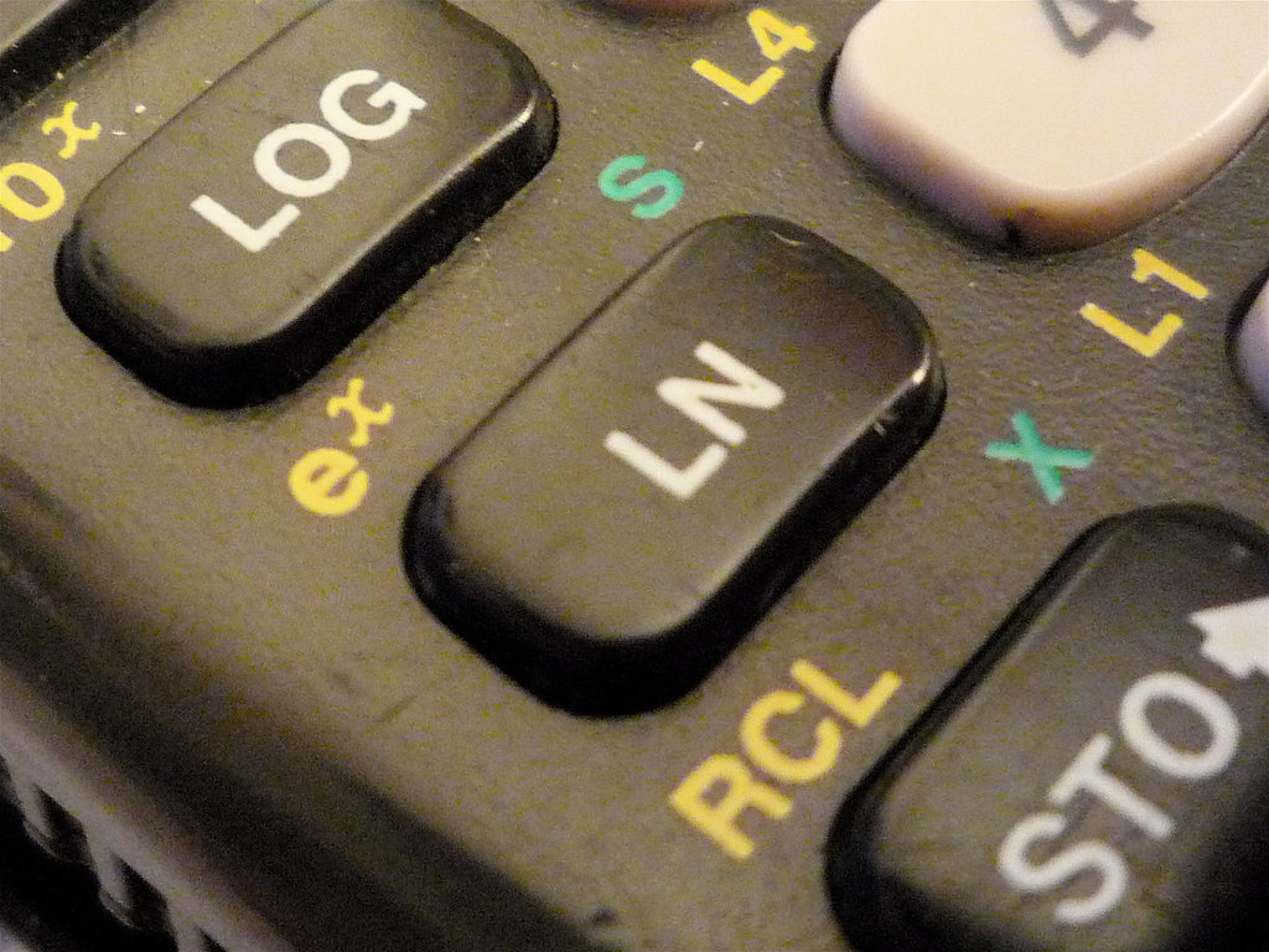 Close-up photo of a scientific calculator showing the LOG and LN keys.